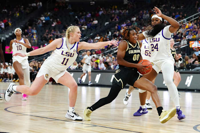 Colorado Buffaloes guard Jaylyn Sherrod (00) drives between LSU Lady Tigers guard Hailey Van Lith (11) and LSU Lady Tigers guard Aneesah Morrow (24) during the fourth quarter at T-Mobile Arena